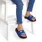 Zed Honra youth sandals in blue – worn by child seated on stool