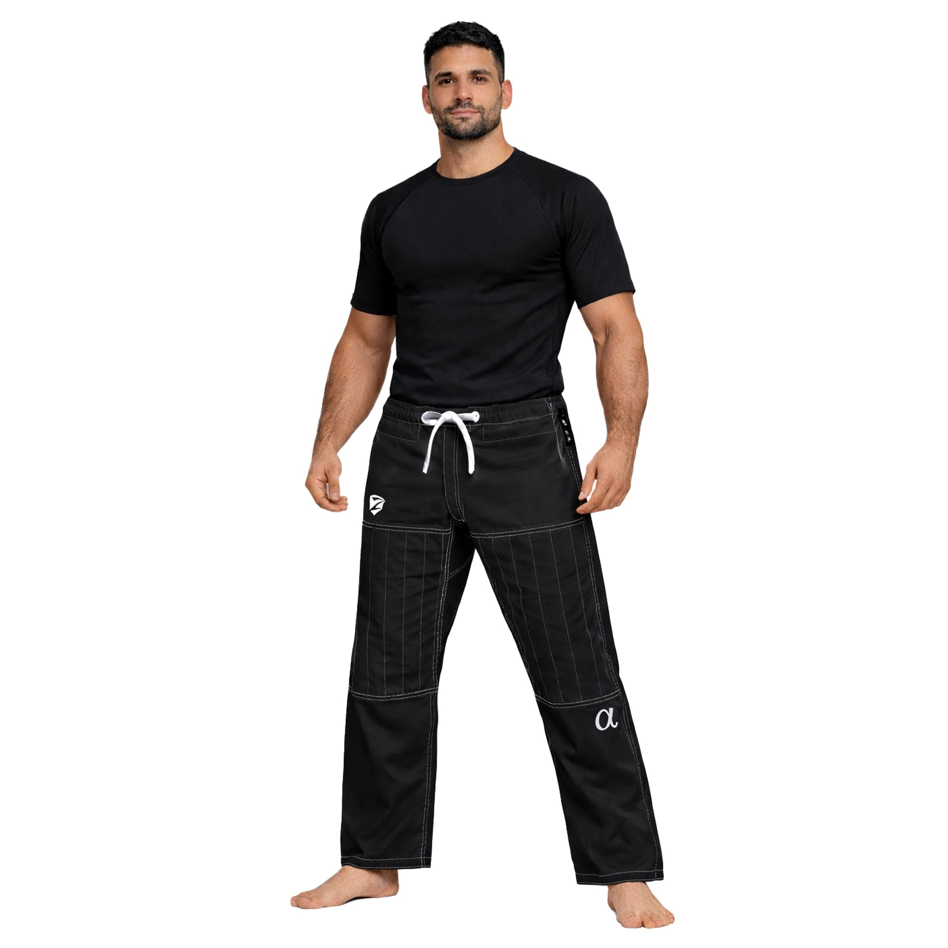 Man wearing black athletic pants and shirt on a white background