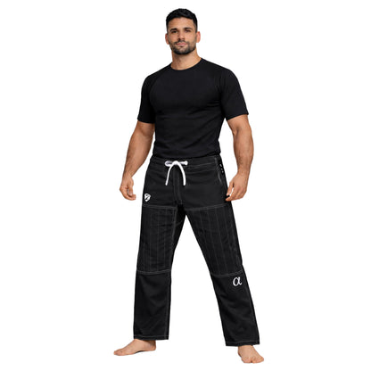 Man wearing black athletic pants and shirt on a white background