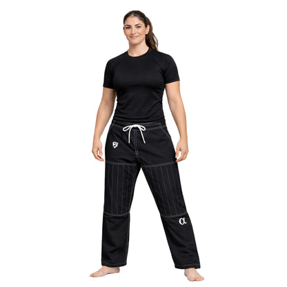 Woman wearing black athletic pants and shirt on a white background