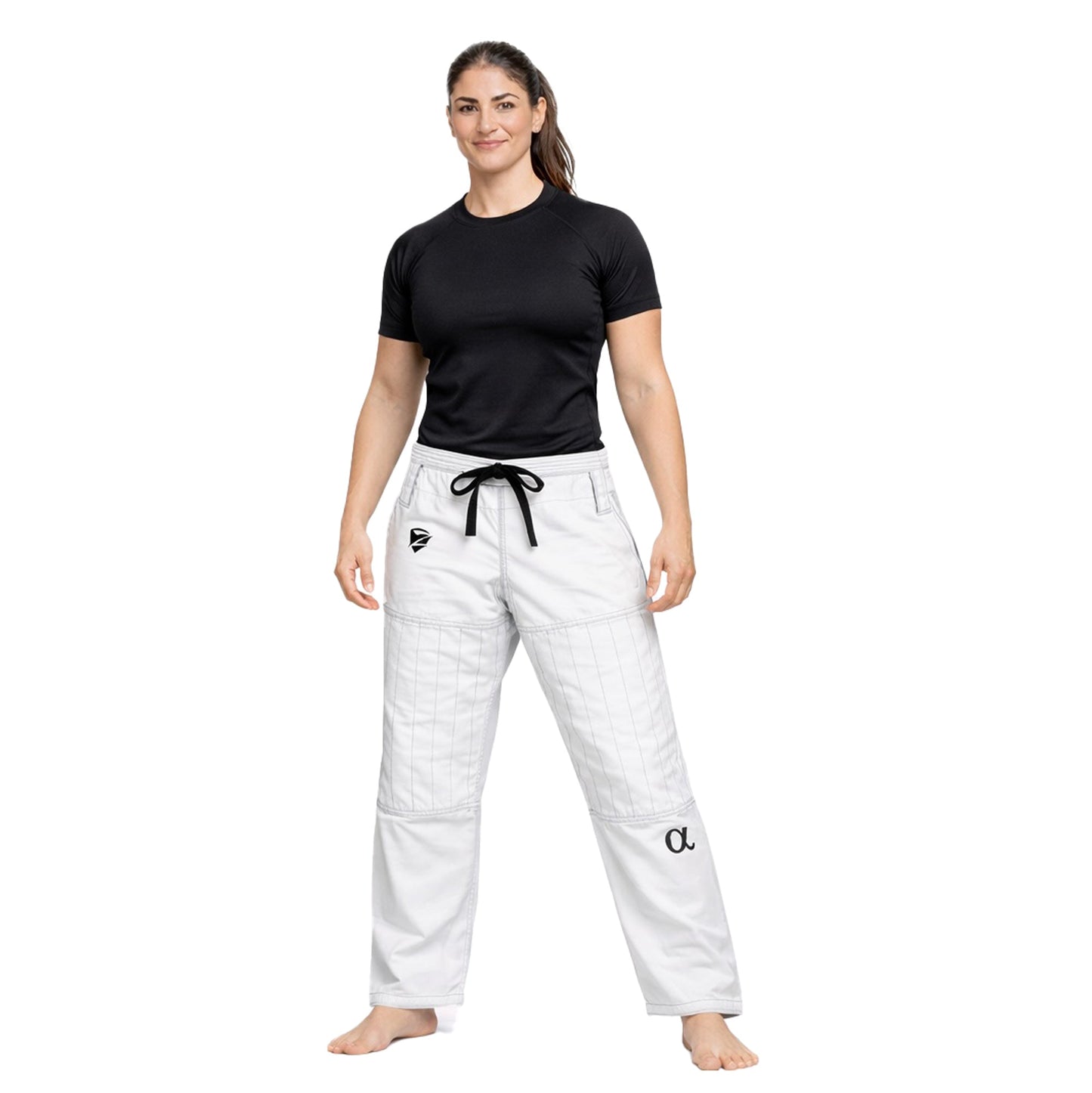Woman wearing a black t-shirt and white pants with a logo on a white background